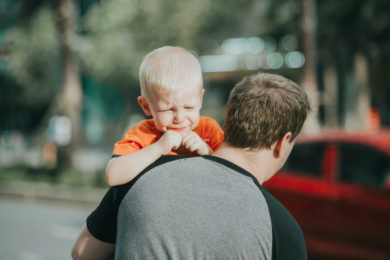 A man carrying a crying child.