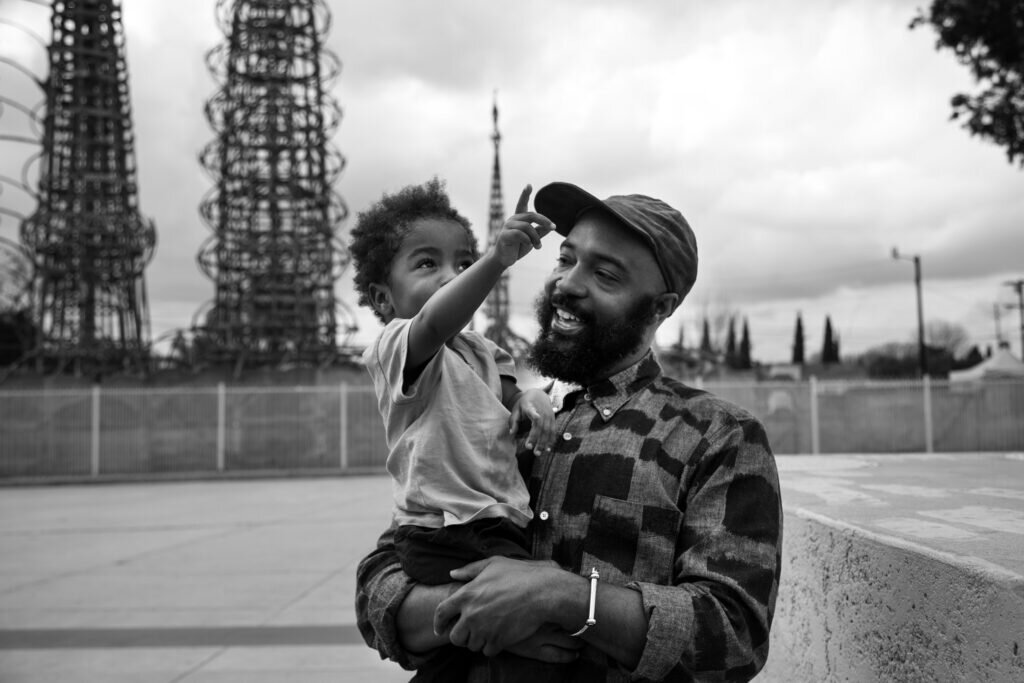 Cinematographer Bradford Young holding his son.