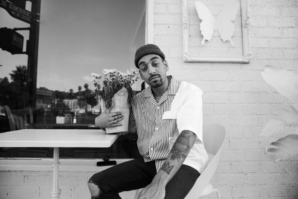 Morgan cooper sitting on a chair holding flowers.