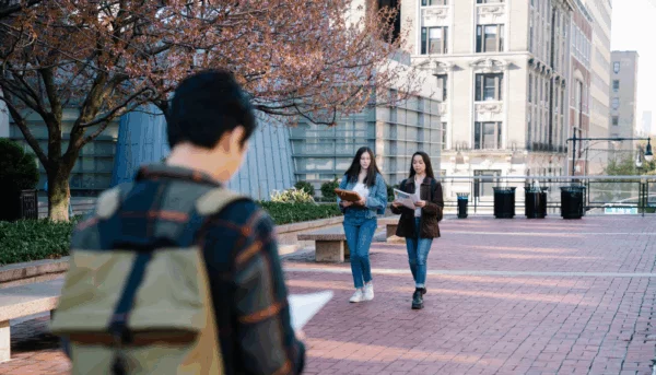 Students walking on a college campus. Students walking on a college campus.