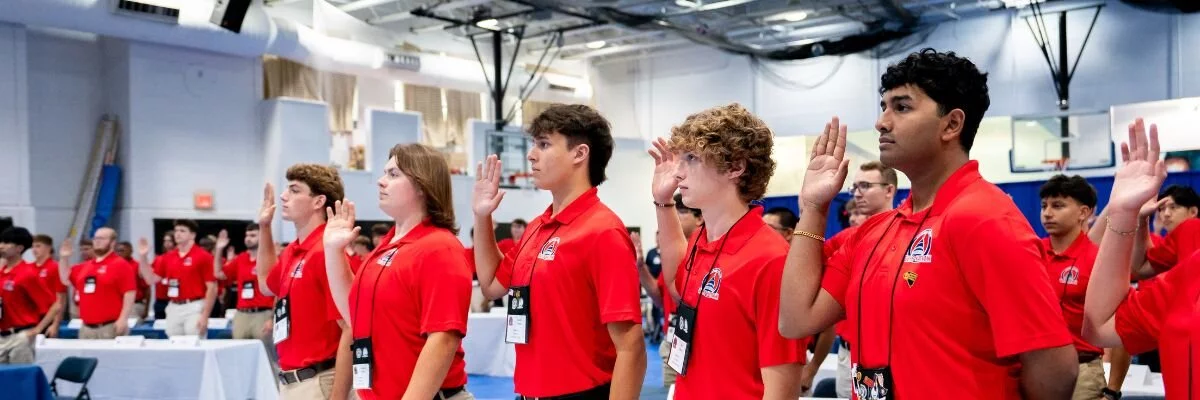 A group of boys swearing an oath.