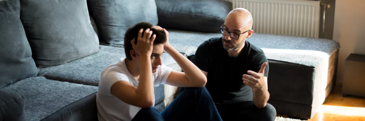 A father talking to their upset son