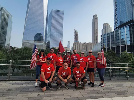 Team RWB posing in front of a cityscape.