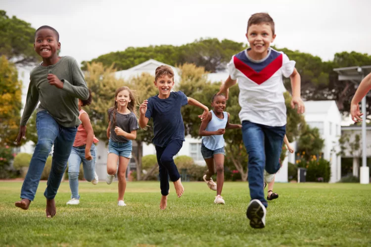 Excited Elementary School Pupils Running Across Field At Break Time 2026/03/AdobeStock_277899316_1-e1772728786239.jpeg 