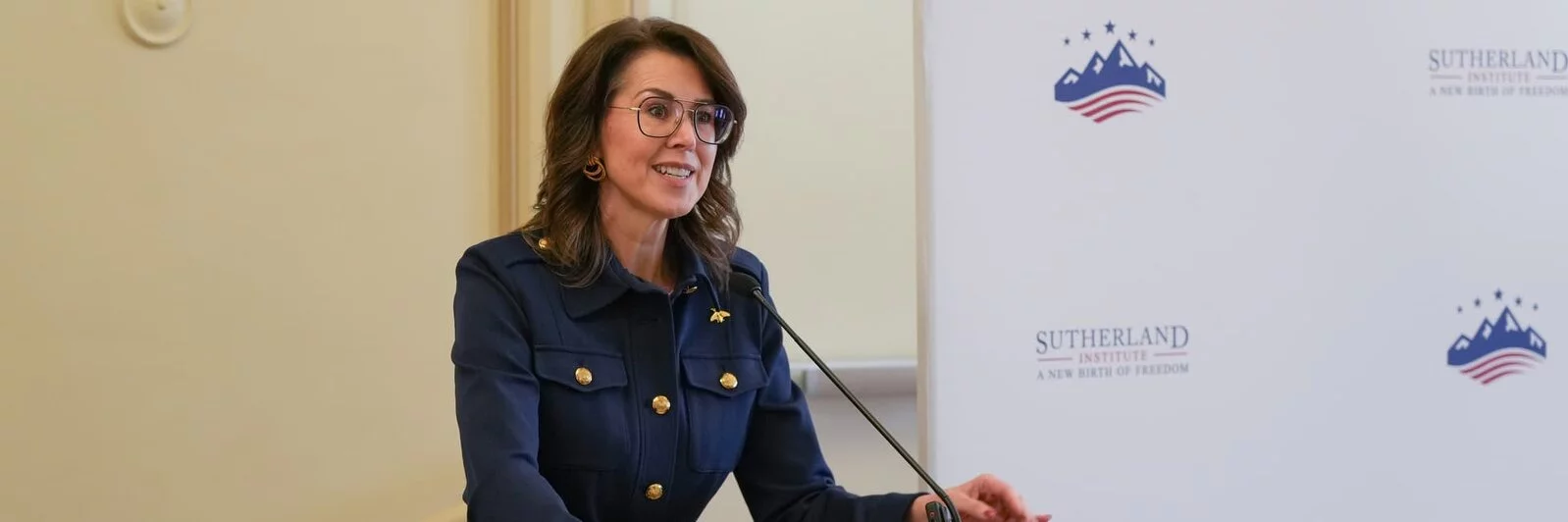 Utah Lt. Governor Diedre Henderson speaking at event on boys and men behind a podium