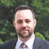 A professional headshot of Steve Ruddock in professional business attire.