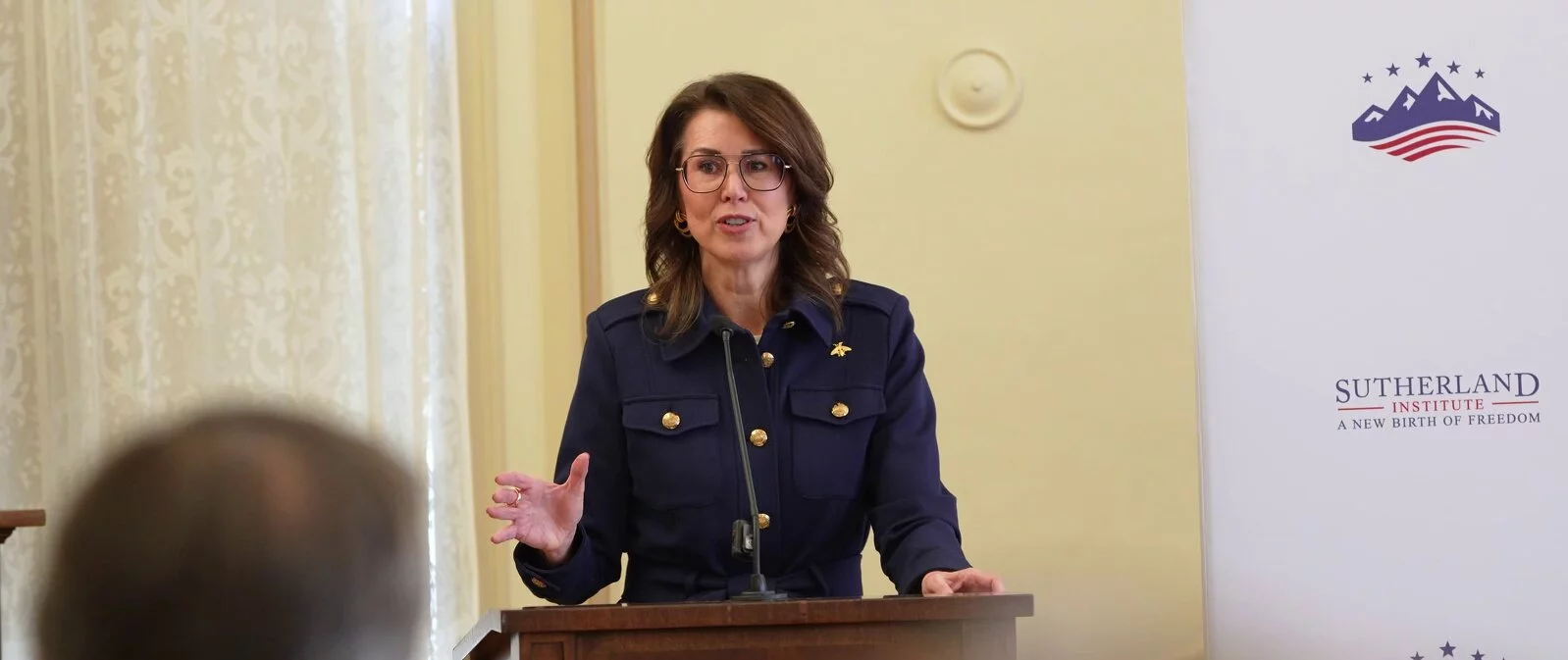 Utah Lt. Governor Diedre Henderson speaking at event on boys and men behind a podium