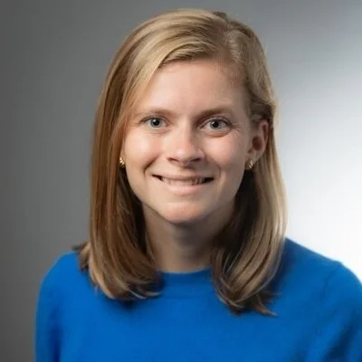 Headshot of Camilla Adams, an economics PhD candidate at Brown University, who researches social mobility and labor markets, specifically examining the impact of Boy Scouts on outcomes.