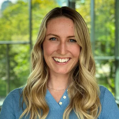 A professional headshot of Jamie Emery, a PhD student at MIT, who studies the effects of public policy on economic opportunity, family stability, and the future of children.