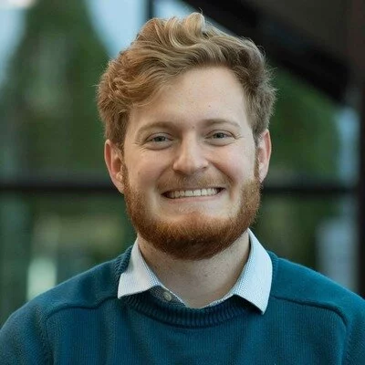 Headshot of Nicholas, a PhD student at Emory University researching male mortality and the health effects of sports gambling, with previous experience in consulting and finance.