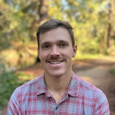 Headshot of Patrick Zimmer, a UC Davis PhD student specializing in human capital development, emphasizing non-classroom influences on children's outcomes.