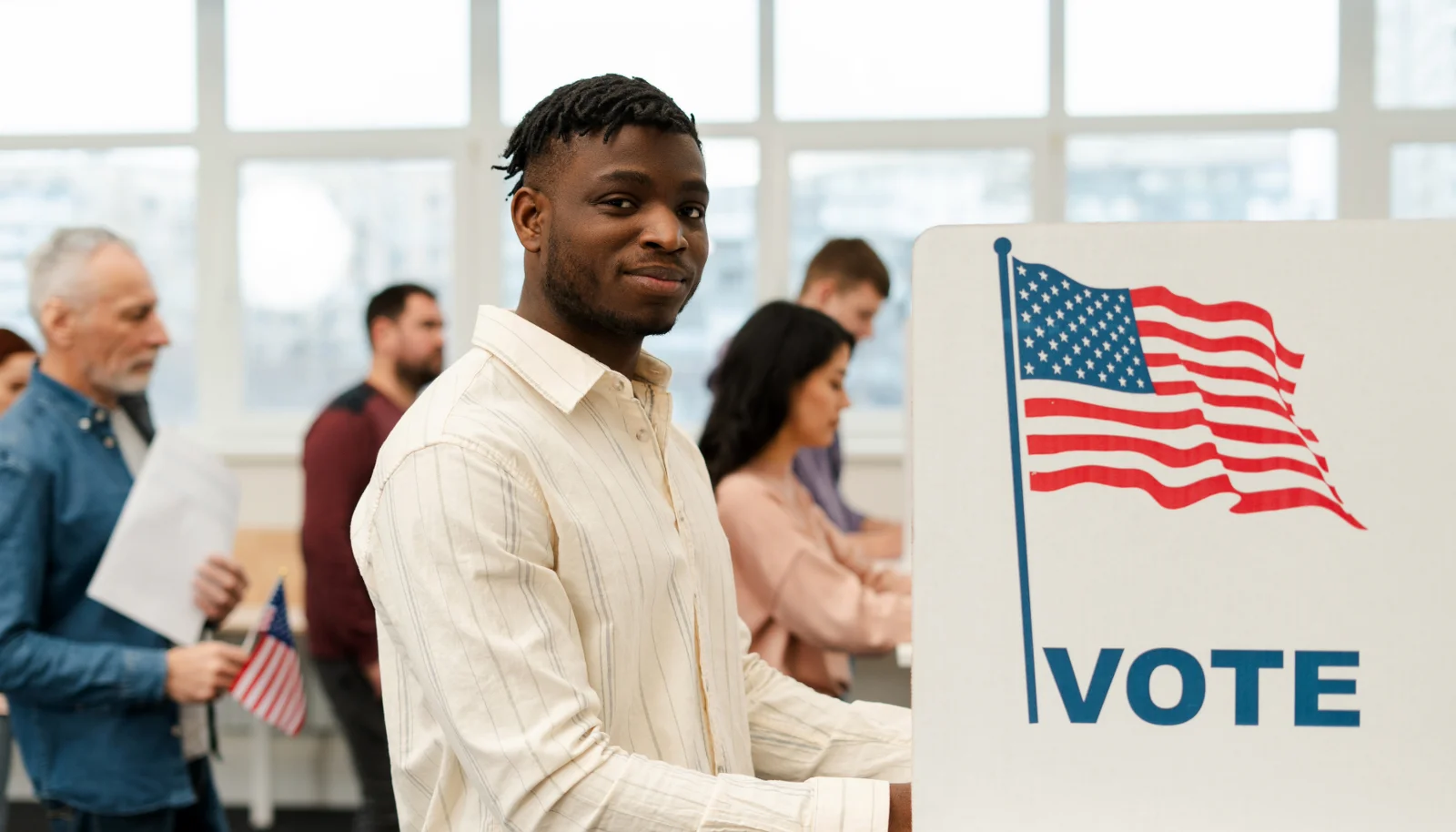 Young man casting vote at polling location