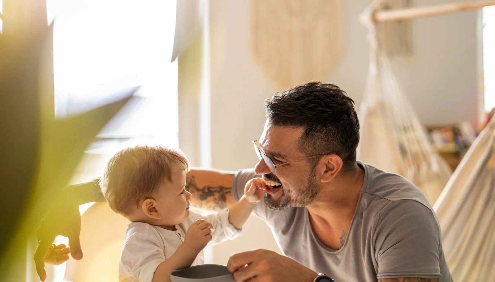  2026/07/Baby-feeds-father-in-well-lit-room.png 