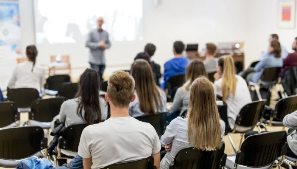College students attend lecture in a well-lit classroom College students attend lecture in a well-lit classroom