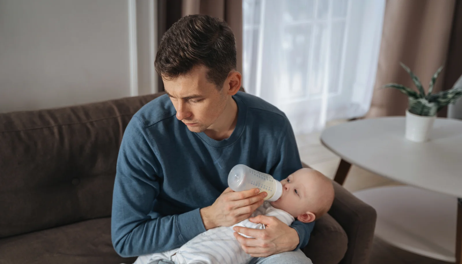 Father giving baby milk