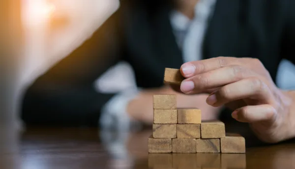 Person stacking wooden blocks together